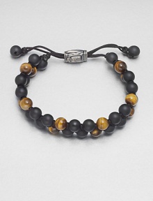 Smooth beaded bracelet of black onyx and tiger's eye with sterling silver lobster clasp.Black onyx/tigers eyeLobster claspAbout 2½ diam.Made in the United Kingdom Smooth beaded bracelet of black onyx and tiger's eye with sterling silver lobster clasp.Black onyx/tigers eyeLobster claspAbout 2½ diam.Made in the United Kingdom
