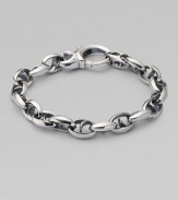 Bold oval links of polished sterling silver have not-so-sinister curved spikes in their centers.Sterling silver Length, about 8½ Lobster clasp Imported