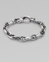 Bold oval links of polished sterling silver have not-so-sinister curved spikes in their centers.Sterling silver Length, about 8½ Lobster clasp Imported