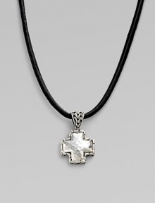 A simple leather cord holds a small cross pendant forged with a hammered finish in pure silver. Cord, 18-20 adjustable Lobster clasp closure Imported 