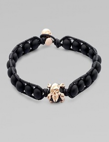 A modern array of black onyx beads are framed by leather detail and finished with a rose gold skull. OnyxLeatherRose goldLength, about 9Diameter, about 3 Clasp closureImported A modern array of black onyx beads are framed by leather detail and finished with a rose gold skull. OnyxLeatherRose goldLength, about 9Diameter, about 3 Clasp closureImported