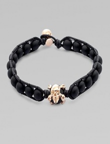 A modern array of black onyx beads are framed by leather detail and finished with a rose gold skull. OnyxLeatherRose goldLength, about 9Diameter, about 3 Clasp closureImported