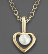 The perfect gift for your favorite little sophisticate. Suspended in the center of this elegant open heart pendant is a lustrous cultured pearl. Crafted of 14k gold. Chain measures 15.