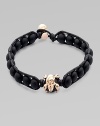 A modern array of black onyx beads are framed by leather detail and finished with a rose gold skull. OnyxLeatherRose goldLength, about 9Diameter, about 3 Clasp closureImported