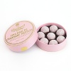 Lightly dusted pink chocolate truffles with a milk chocolate butter and Marc de Champagne center.
