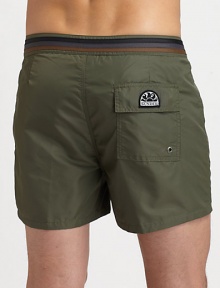 Comfortable swim trunks, in quick-drying nylon, are highlighted by a striped detail along the waistband and back flap pocket with grip-tape closure.Snap button-frontRear flap pocketInseam, about 3NylonMachine washImported Comfortable swim trunks, in quick-drying nylon, are highlighted by a striped detail along the waistband and back flap pocket with grip-tape closure.Snap button-frontRear flap pocketInseam, about 3NylonMachine washImported