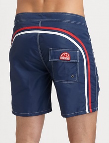 Solid, quick-drying swim trunks have a lace-up waist and signature rainbow detail across the back and down the leg.Drawstring waistRear flap pocketInseam, about 6NylonMachine washImported Solid, quick-drying swim trunks have a lace-up waist and signature rainbow detail across the back and down the leg.Drawstring waistRear flap pocketInseam, about 6NylonMachine washImported