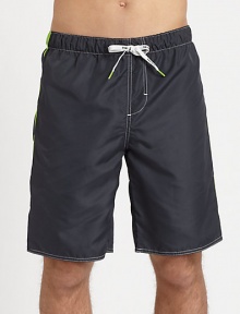 Classic swim trunk style, in quick-drying nylon, finished with a back patch pocket and vibrant contrast tipping.Elastic drawstring-tie waistBack patch pocketInseam, about 9PolyesterMachine washImported Classic swim trunk style, in quick-drying nylon, finished with a back patch pocket and vibrant contrast tipping.Elastic drawstring-tie waistBack patch pocketInseam, about 9PolyesterMachine washImported