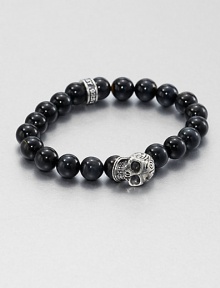 A striking skull pendant of sterling silver accents a stretch beaded bracelet of blue tigers' eye for the modern man of style.Sterling silverTigers' eyeWidth, about 10mmDiameter, about 3Made in USA