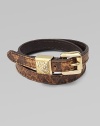 Supple, snake-print leather in a chic, double-wrap design with a logo accented buckle and rhinestone detailed, pyramid keeper. Snake-print leatherBrass and zincGlass stonesLength, about 16Buckle closureImported 