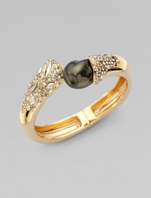 A striking black baroque-shaped shell pearl dramatically caps one end of a Swarovski crystal-laden bangle with a gleaming golden finish.CrystalShell pearl18k goldplatedDiameter, about 2¼Width, about ½Hinged with magnetic claspMade in USA A striking black baroque-shaped shell pearl dramatically caps one end of a Swarovski crystal-laden bangle with a gleaming golden finish.CrystalShell pearl18k goldplatedDiameter, about 2¼Width, about ½Hinged with magnetic claspMade in USA