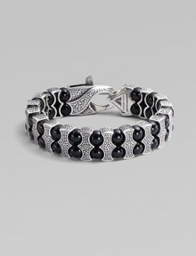 Architectural drama defines this bold bracelet, constructed of double rows of black onyx beads held by scalloped pillars of sterling silver. Black onyx Sterling silver Length, about 8¾ Lobster clasp Imported Architectural drama defines this bold bracelet, constructed of double rows of black onyx beads held by scalloped pillars of sterling silver. Black onyx Sterling silver Length, about 8¾ Lobster clasp Imported