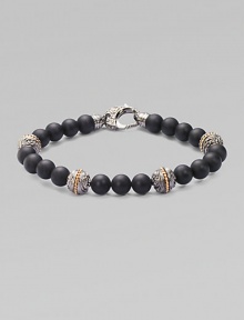 A bold statement in sterling silver and matte onyx with handsome engraved detail. Sterling silver Onyx 8mm beads About 9 long Imported 