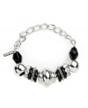 Bold beaded design takes your look to new heights. Nine West's stretch bracelet slips effortlessly over your wrist and provides a look that's polished and chic. Plastic jet beads and clear stones shine in a silver tone mixed metal setting. Approximate diameter: 2-1/4 inches.