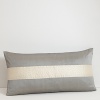 A solid stripe jets down the center of this decorative pillow, giving it a pop of shimmering color.