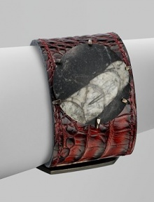 A beautiful contrast of textures and colors with this natural, statement piece featuring a fossil in smooth stone. Orthoceras fossil in stoneBrassCroc embossed leatherLength, about 1¾ to 2½ adjustableBuckle closureMade in USAPlease note: Stone size and appearance may vary. A beautiful contrast of textures and colors with this natural, statement piece featuring a fossil in smooth stone. Orthoceras fossil in stoneBrassCroc embossed leatherLength, about 1¾ to 2½ adjustableBuckle closureMade in USAPlease note: Stone size and appearance may vary.