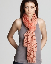 A large patchwork of various floral print decorate this cozy wool scarf from Tory Burch. A large patchwork of various floral print decorate this cozy wool scarf from Tory Burch.