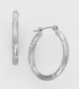 The classic hoop earring in cool white gold. 14k white gold hoop is diamond cut for extra glimmer. Wire-catch closure. For pierced ears only.