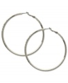Sophisticated in silver. These classic hoop earrings from GUESS showcase subtle texture for added style. Crafted in silver tone imitation rhodium mixed metal. Approximate diameter: 2-1/2 inches.