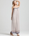 A flowing Vince maxi dress is the picture of boho with a delicate print and feminine piping at the sides for dainty detail. Strappy sandals finish the look with an earthy sensibility.