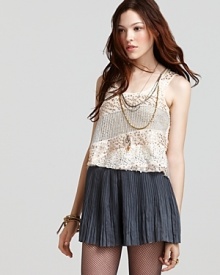 A glitzy Free People tank boasts diagonal alternating stripes of sheer knit and metallic and sequined fabric for a festive holiday look that dazzles with decadence. A glitzy Free People tank boasts diagonal alternating stripes of sheer knit and metallic and sequined fabric for a festive holiday look that dazzles with decadence.