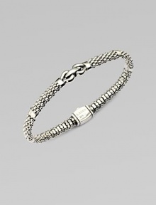 An elegant piece with in textured sterling silver accented with a center link detail . Sterling silverDiameter, about 2¼Box clasp closureImported 