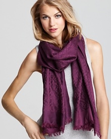Decorated by a jacquard pattern of iconic Ts, this beautiful Tory Burch scarf channels stay-warm style. Decorated by a jacquard pattern of iconic Ts, this beautiful Tory Burch scarf channels stay-warm style.