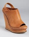 A clog-inspired silhouette from Boutique 9, featuring a feminine braided trim at the mid-sole and rich, lightly-distressed leather.