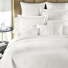 The signature Charisma dot in white cotton, with cross-stitch embroidery inset. The signature Charisma dot in white cotton, with cross-stitch embroidery inset.