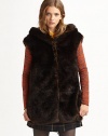 Top off any ensemble with a hint of plush in this shimmering faux fur vest with a cold-conquering hood and convenient snap closures. Attached hoodSnap closuresFully linedAbout 29 from shoulder to hem87% modacrylic/13% polyesterDry cleanMade in USA of Italian fabricModel shown is 5'10 (177cm) wearing US size 2.