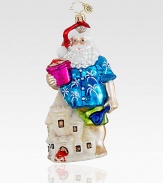 Everyone needs a break! A Hawaiian shirt-clad Santa makes a pit stop at the beach to make some impressive sandcastles. Hand-blownHand-painted5½ tallMade in Poland