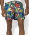 A classic-fitting swim trunk is designed in super-soft, quick-dry microfiber with a tropical parrot print for the ultimate beach-ready style.