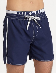 Classic swim trunk style, in quick-drying nylon, finished with a signature elastic logo waistband.Elastic drawstring-tie waistBack patch pocketInseam, about 6PolyesterMachine washImported Classic swim trunk style, in quick-drying nylon, finished with a signature elastic logo waistband.Elastic drawstring-tie waistBack patch pocketInseam, about 6PolyesterMachine washImported