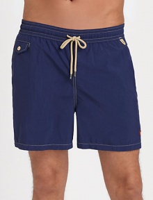 The classic Traveler swim short is rendered in sleek, quick-drying microfiber in a vibrant plaid pattern for cool, casual beach style.Elastic waistband with drawstring tie closureSide slash pocketsBack waist drainage grommetsBack flap patch pocketMesh liningInseam, about 4¾NylonMachine washImported