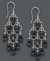 Perfect your soiree look with statement-making earrings. A delicate sterling silver setting highlights faceted, pear-shaped onyx stones (5 mm x 8 mm). Approximate drop: 2 inches.