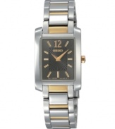 As indispensable as a pair of pearl earrings, this Seiko watch is the classic everyday watch. Two-tone stainless steel bracelet and rectangular case. Charcoal dial with striped inner dial features goldtone numeral at twelve o'clock, stick indices, two hands and logo. Quartz movement. Water resistant to 30 meters. Three-year limited warranty.