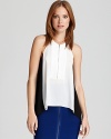 An exposed front zip adds edge to this BCBGMAXAZRIA top, featuring trend-perfect color blocking for a graphic punch.