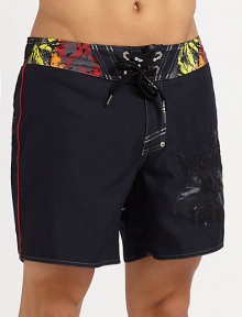 Colorful graphic prints adorn this quick-drying, cropped swim style.Drawstring tie waistRear patch pocketInseam, about 7PolyesterMachine washImported Colorful graphic prints adorn this quick-drying, cropped swim style.Drawstring tie waistRear patch pocketInseam, about 7PolyesterMachine washImported