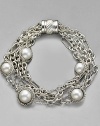 Pearls from the deep are captured in a cabled settings tangled in a netting of sterling chains. Mixed link bracelet 7½ long Cable barrel clasp Imported