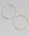 Hoops of 14k gold wire are set with faceted sterling silver beads that catch and reflect light with a warm radiance.14k yellow gold and sterling silverDiameter, about 1½Ear wireMade in USA