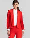 Clean lines and sharp tailoring lend architectural inspiration to this Calvin Klein jacket, finished in a vibrant hue for a thoroughly modern silhouette. Slip a jewel-tone blouse under the style for sleek color blocking.