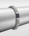 From the Muse Collection. An iconic caviar texture in sleek sterling silver accented with a rich blue sapphire station. Sterling silverBlue sapphireLength, about 7.5Box and tongue closureImported 