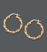 Add a rich twist to your look. Traditional hoops offer a special touch with a unique twisted design crafted in 14k gold. Approximate diameter: 1-1/4 inches.