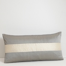 A solid stripe jets down the center of this decorative pillow, giving it a pop of shimmering color. A solid stripe jets down the center of this decorative pillow, giving it a pop of shimmering color.