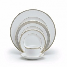 Rings of gold adorn fine white bone china with the lustrous shine of a wedding band. White bone china features two different border trims of gold, a wide corded border of textured grosgrain ribbon on some pieces, a narrow edge on others. Rings of gold adorn fine white bone china with the lustrous shine of a wedding band. White bone china features two different border trims of gold, a wide corded border of textured grosgrain ribbon on some pieces, a narrow edge on others.