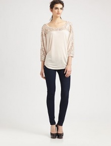 Metallic lace trim outlines this lengthy dolman top of ultra-soft modal. Wide roundneckButton frontDropped shouldersThree-quarter dolman sleevesBack contour hemMicro modalDry cleanMade in USAModel shown is 5'10 (177cm) wearing US size Small. Metallic lace trim outlines this lengthy dolman top of ultra-soft modal. Wide roundneckButton frontDropped shouldersThree-quarter dolman sleevesBack contour hemMicro modalDry cleanMade in USAModel shown is 5'10 (177cm) wearing US size Small.