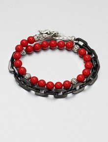 This chain link and beaded, multi-row design of stainless steel and sterling silver is embellished with red coral for a colorful, charismatic touch.Stainless steel/sterling silverCoralAbout 3 diam.Imported