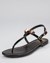 A charming pair of sandals from VINCE CAMUTO, adorned with a girlish bow made edgy by metal materials.