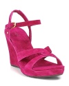 Soft suede straps, twisted at the toe and buckled at the ankle, perch on a comfortable wedge.