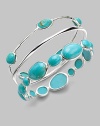 From the Scultura Collection. Shapes of brilliant turquoise cabochon, richly framed in sterling silver, vibrantly decorate the wrist.Turquoise cabochon Sterling silver Diameter, about 2½ Imported